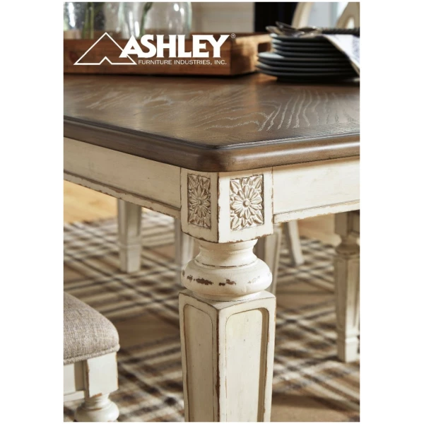 Η τραπεζαρία Realyn, της Ashley, με  επεκτεινόμενο τραπέζι και έξι καρέκλες, έχει χρώμα σε παλαιωμένο λευκό. Οι καρέκλες έχουν κορδελωτό σχέδιο στην πλάτη.
