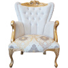 Μπερζέρα, με καπιτονέ πλάτη και αφράτο μαξιλάρι καθίσματος, επενδεδυμένος με φλοράλ ταπετσαρία, σε χρυσό και καφέ χρώμα.